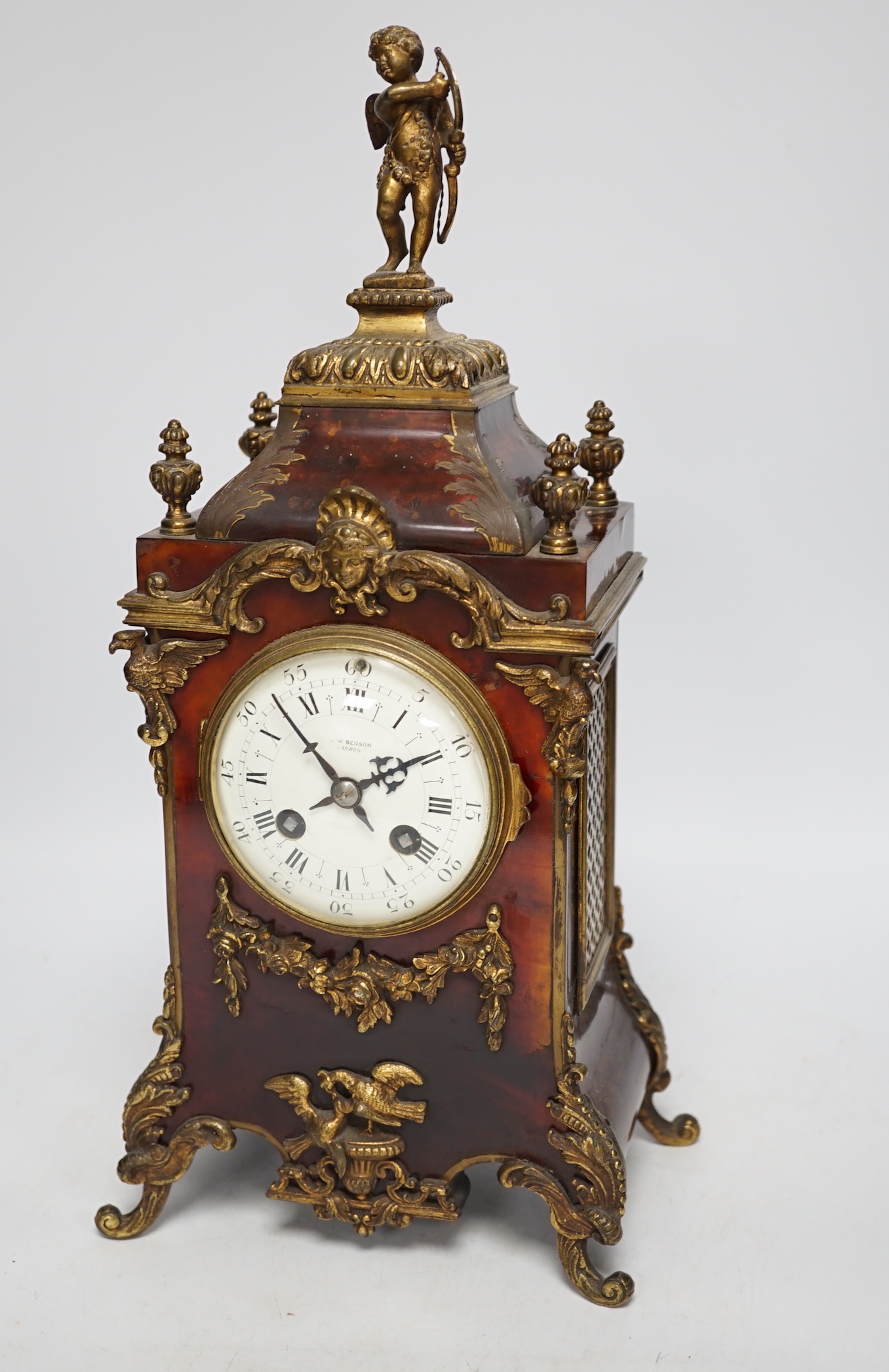 A late 19th century French tortoiseshell veneered mantel clock with cupid top, striking on a coiled gong, dial signed Benson, London, 39.5cm